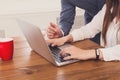 Businessman supervising secretary work on laptop, closeup of hands, unrecognizable Royalty Free Stock Photo