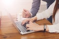 Businessman supervising secretary work on laptop, closeup of hands, unrecognizable Royalty Free Stock Photo