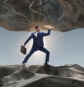 Businessman supporting stone under pressure Royalty Free Stock Photo