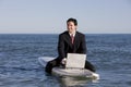 Businessman on Surfboard