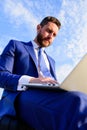 Businessman surfing internet or reply emails while sit with laptop outdoors. Sales manager works on internet marketing Royalty Free Stock Photo