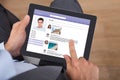 Businessman surfing social networking site on digital tablet