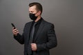 Businessman with surgical medical mask using cellphone Royalty Free Stock Photo