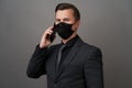 Businessman with surgical medical mask using cellphone Royalty Free Stock Photo