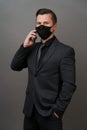 Businessman with surgical medical mask using cellphone Royalty Free Stock Photo