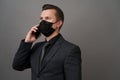 Businessman with surgical medical mask using mobile phone Royalty Free Stock Photo