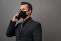 Businessman with surgical medical mask using mobile phone Royalty Free Stock Photo