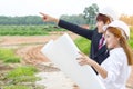 Businessman surveying land for industrial project.Selective focus at hand