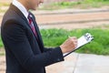 Businessman surveying land for industrial project.Selective focus at hand