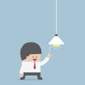 Businessman switching on light bulb, Idea concept