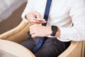 Businessman syncing smart watch to his phone