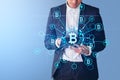 Businessman with tablet, bitcoin hologram icons and blockchain Royalty Free Stock Photo