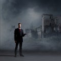 Businessman standing over apocalyptic background. Crisis, default, setback concept.