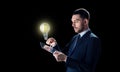 Businessman with tablet pc and lightbulb