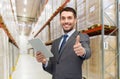 Businessman with tablet pc over warehouse Royalty Free Stock Photo