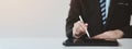 Businessman with a tablet, he uses the tablet to view business documents and communicate sending e-mail messages over the internet