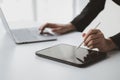 Businessman with a tablet, he uses the tablet to view business documents and communicate sending e-mail messages over the internet