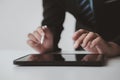 Businessman with a tablet, he uses the tablet to view business documents and communicate sending e-mail messages over the internet