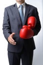 Businessman take off boxing gloves to offer a handshake on white