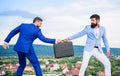 Businessman takes away briefcase from business partner. Fraud and extortion concept. Rascal racketeer extortionist Royalty Free Stock Photo