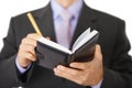 Businessman takes notes in notebook - closeup Royalty Free Stock Photo