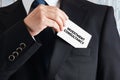 Businessman takes out a business card with the word investment consultancy. Business investment consultant Royalty Free Stock Photo