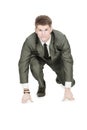 Businessman taking low start to running. On white background. Royalty Free Stock Photo