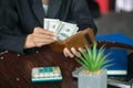 Businessman taking money out of his wallet, man hand wallet and money on table Royalty Free Stock Photo