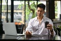 A businessman taking notes on his notebook while having afternoon coffee at a coffee shop Royalty Free Stock Photo