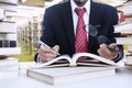 Businessman taking notes at library Royalty Free Stock Photo