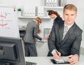 Businessman taking notes and smiles Royalty Free Stock Photo