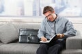 Businessman taking notes on sofa