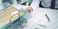 Businessman taking a record of his paper tray, geometric pattern