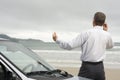 Businessman talking on cell phone beside his car Royalty Free Stock Photo