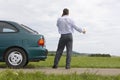 Businessman talking on cell phone beside his car Royalty Free Stock Photo