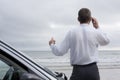 Businessman talking on cell phone at the sea Royalty Free Stock Photo