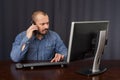 Businessman talking on cellphone while working Royalty Free Stock Photo