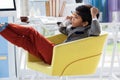 Businessman talking on landline phone while sitting on armchair