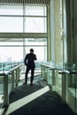 Businessman talking on mobile phone in corridor at modern office building Royalty Free Stock Photo