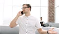 Businessman talking on a mobile phone in the lobby of the business center Royalty Free Stock Photo