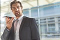 Businessman talking on mobile phone in lobby office Royalty Free Stock Photo