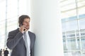 Businessman talking on mobile phone in lobby office Royalty Free Stock Photo