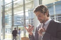 Businessman talking on mobile phone in lobby office Royalty Free Stock Photo