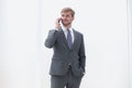 Businessman talking on a mobile phone standing near the office window Royalty Free Stock Photo