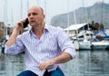 Businessman talking on the phone close to the luxurious harbor Royalty Free Stock Photo