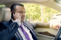 Businessman talking on the phone while driving in a traffic jam. Portrait of a driver, a man looking at the road