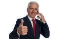 Businessman talking on the phone and giving a like Royalty Free Stock Photo