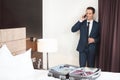 Businessman talking on phone in hotel room Royalty Free Stock Photo