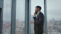 Businessman talking phone negotiations standing at office window. Business call Royalty Free Stock Photo