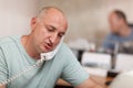 Businessman talking on phone in office